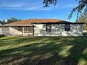 House exterior showcasing a screened patio and side yard at 602 Mesilla Dr, Kissimmee, FL 34758