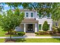 Two-story house with front yard and walkway at 7423 Sparkling Ct, Reunion, FL 34747