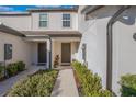 Townhome entry with walkway, landscaping, and two private entrances at 1592 Wynford Cir, Tavares, FL 32778