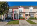Two-story townhome with a light tan exterior and landscaping at 2361 Silver Palm Dr, Kissimmee, FL 34747