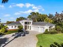 Stunning two-story home with a three-car garage and a beautiful lawn at 2810 Lake Howell Ln, Winter Park, FL 32792