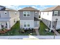 Two-story house with gray siding, light-blue door, and small front yard at 4704 Homestead Trl, St Cloud, FL 34772