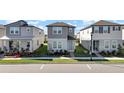 Three-story townhouses with front yards and parking at 4704 Homestead Trl, St Cloud, FL 34772