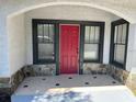 Inviting entryway with red door and stone accents at 221 N Julia Ave, Deland, FL 32720