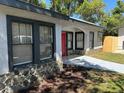 Front view of a renovated home with stone and gray siding at 221 N Julia Ave, Deland, FL 32720