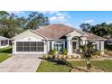 Single-story house with a two-car garage and landscaped front yard at 2441 Derby Dr, Deltona, FL 32738