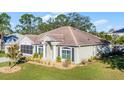 Single-story house with a two-car garage and landscaped front yard at 2441 Derby Dr, Deltona, FL 32738