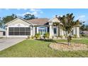 Single-story house with a two-car garage and landscaped front yard at 2441 Derby Dr, Deltona, FL 32738