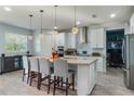 Spacious kitchen with white cabinets, granite countertops, and island seating at 2609 Mead Ave, St Cloud, FL 34771