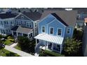 Two-story craftsman style homes with front porches at 7309 Tidepool Pl, Celebration, FL 34747