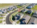 An aerial view showcasing a house with a pool in a neatly planned community at 4381 Davos Dr, Clermont, FL 34711