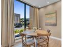 Charming dining area with round table and four chairs, near a large window at 7598 Brooklyn Dr, Kissimmee, FL 34747