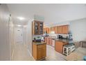Bright kitchen with wood cabinets and stainless steel appliances at 7707 Country Pl, Winter Park, FL 32792