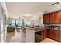 Open kitchen with granite countertops and dark wood cabinets at 903 Charo Pkwy # 836, Davenport, FL 33897