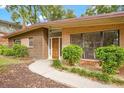 Brick and wood exterior with walkway and landscaping at 1755 Sunset Dr, Clermont, FL 34711