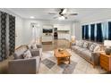 Bright living room with comfy seating and a view of the kitchen at 2410 Sanford Ave, Sanford, FL 32771