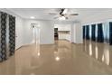 Open concept living room and kitchen with shiny floors and ceiling fan at 2410 Sanford Ave, Sanford, FL 32771