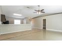 Bright living room with tile floors and a view to the kitchen at 2461 Omaha Dr, Deltona, FL 32738