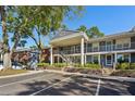 Two-story building with gray siding, balconies, and ample parking at 5417 Lake Margaret Dr # G, Orlando, FL 32812