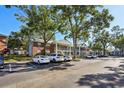 Building exterior showcasing parking lot and lush green trees at 5417 Lake Margaret Dr # G, Orlando, FL 32812