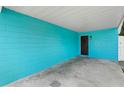 Covered side entrance with teal painted brick exterior at 1090 Henry Balch Dr, Orlando, FL 32810