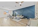 Light and airy living room with blue accent wall and stylish furniture at 10974 Savannah Landing Cir # 0, Orlando, FL 32832