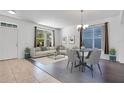 Bright living room with hardwood floors, comfy seating, and large windows at 14643 Tanja King Blvd, Orlando, FL 32828