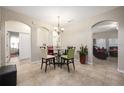Dining room with glass table and four chairs, view of living room at 2338 Darlin Cir, Orlando, FL 32820