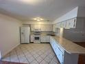 Galley style kitchen with white appliances at 4518 Watch Hill Rd, Orlando, FL 32808