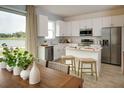 Modern kitchen with white cabinets, stainless steel appliances, and island at 1321 Stockwell Ave, Saint Cloud, FL 34771