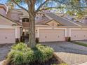 Two-story townhome with a two-car garage and lush landscaping at 8336 Riverdale Ln, Davenport, FL 33896