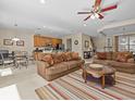 Spacious living room with comfortable seating and a view into the kitchen at 8336 Riverdale Ln, Davenport, FL 33896
