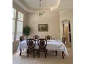 Formal dining room featuring a large table and elegant light fixture at 912 Hire Cir, Ocoee, FL 34761