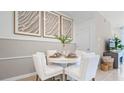 Small dining area with round table and four white chairs at 1006 Lido Dr, Howey In The Hills, FL 34737