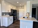 Modern kitchen with white cabinets and quartz countertops at 1023 S Hiawassee Rd # 4022, Orlando, FL 32835