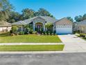 Stunning one-story house featuring stone accents and a lush, well-maintained lawn at 113 Lena Ann Dr, Saint Cloud, FL 34771