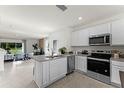 Open concept kitchen with island, stainless steel appliances, and granite countertops at 3337 Private Oak Dr, Apopka, FL 32703