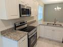 Modern kitchen featuring granite countertops and stainless steel appliances at 6929 Central Ave, Mulberry, FL 33860