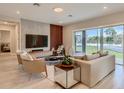 Spacious living room with modern furniture and sliding glass doors to backyard at 8192 Ludington Cir, Orlando, FL 32836