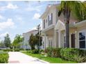 Tan two-story home with brown shutters and landscaping at 8953 Shine Dr, Kissimmee, FL 34747