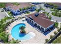 Community pool with clubhouse and lounge chairs at 8953 Shine Dr, Kissimmee, FL 34747