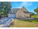 Two-story house with a large driveway, attached garage, and landscaped yard at 1250 Woodridge Ct, Altamonte Springs, FL 32714