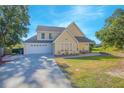Two-story house with a large driveway, attached garage, and landscaped yard at 1250 Woodridge Ct, Altamonte Springs, FL 32714