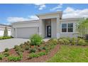 New single-story home with gray siding, white trim, and a landscaped front yard at 1258 Venice Ct, Deland, FL 32724