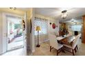 Bright dining room featuring a rustic wooden table and neutral decor at 2032 Dumas Dr, Deltona, FL 32738