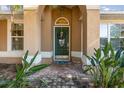 Green front door with a wreath and decorative stone walkway at 5019 Log Wagon Rd, Ocoee, FL 34761