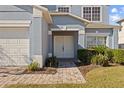 Front entrance of a two-story house with a double door and a brick walkway at 755 Kildrummy Dr, Davenport, FL 33896