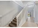 Interior view of a staircase with white railings leading to the second floor at 755 Kildrummy Dr, Davenport, FL 33896