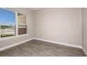 Bright bedroom with large window and wood-look flooring at 925 Tassleflower Trl, St Cloud, FL 34771