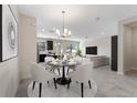 Bright dining room with a round table and modern chairs at 1204 Payne Stewart Dr, Davenport, FL 33896